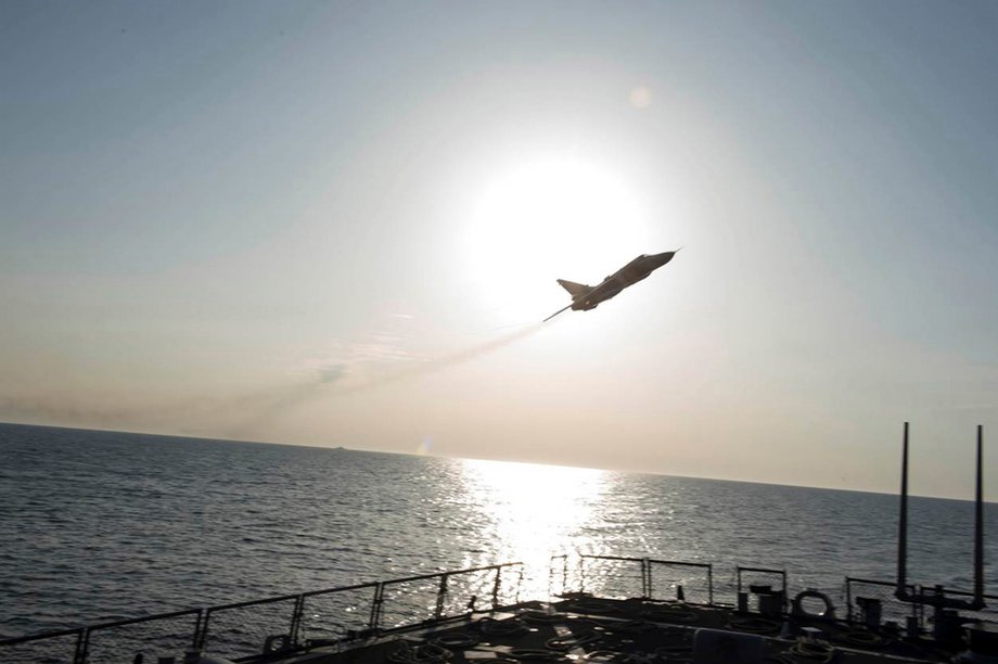 A US Navy picture shows what appears to be a Russian Sukhoi SU-24 attack aircraft flying over the USS Donald Cook in the Baltic Sea, April 12, 2016.