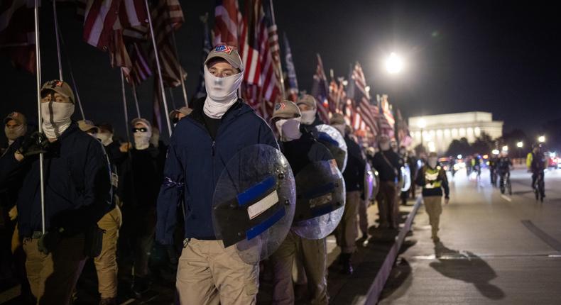 Members of the right-wing group Patriot Front march across Memorial Bridge in front of the Lincoln Memorial on December 04, 2021 in Washington, DC.