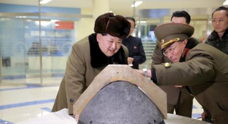 North Korean leader Kim Jong Un looks at a rocket warhead tip after a simulated test of atmospheric re-entry of a ballistic missile, at an unidentified location in this undated file photo released by North Koreas Korean Central News Agency (KCNA) in Pyongyang on March 15, 2016.