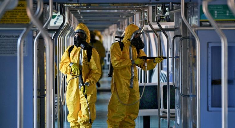 Brazilian soldiers disinfect a train wagon at the central station in Rio de Janeiro