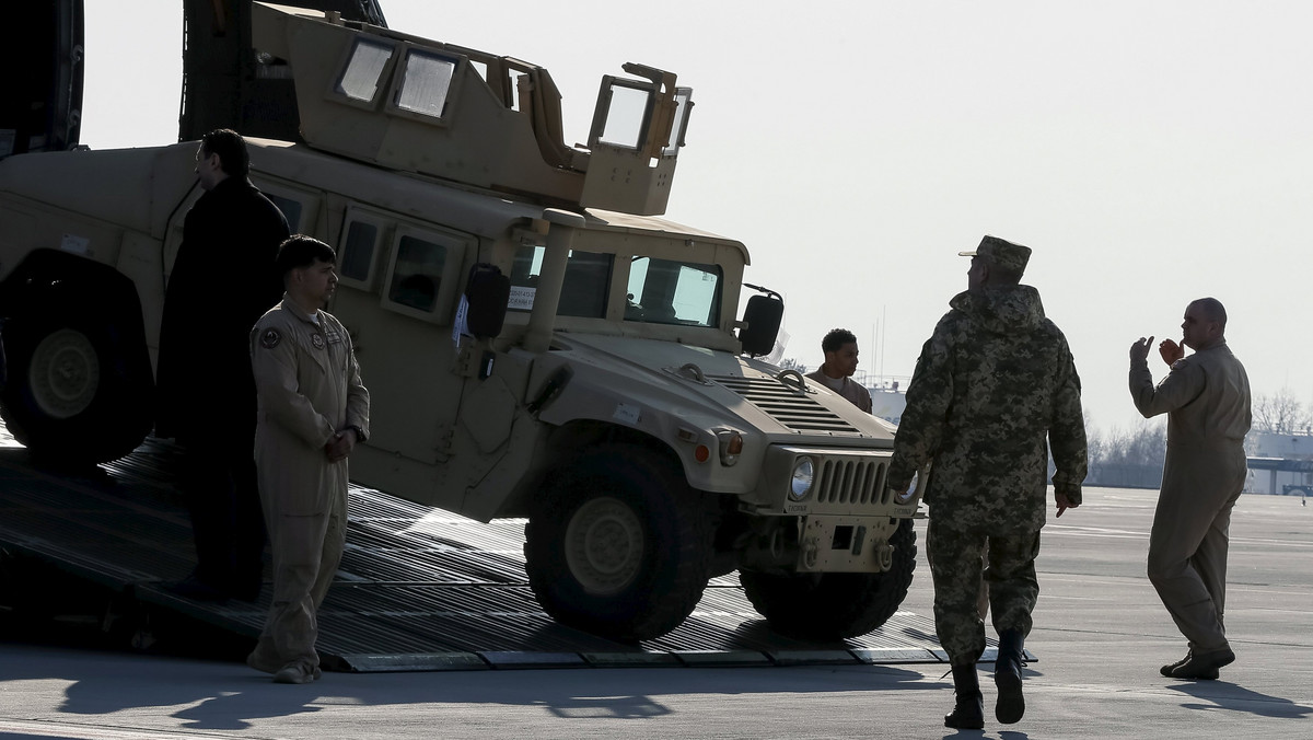 A Ukrainian serviceman looks as first plane from United State with non-lethal aid including ten Humvee vehicles unload in Ukraine at Borispol airport near Kiev