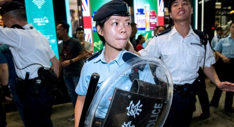 Hong Kong's police officers intervene in an altercation between Pro-China protesters and pro-independence representatives during President of China Xi Jinping's three-day visit to mark the 20th anniversary of the handover from Britain to China