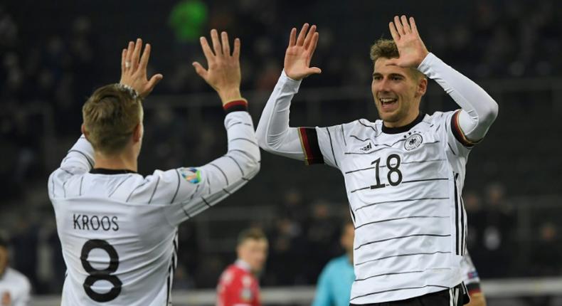 Goal scorers Leon Goretzka (R) and Toni Kroos (L) celebrate as Germany brushed past Belarus with a 4-0 win to qualify for Euro 2020