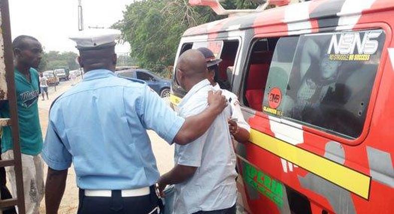 File image of a traffic police officer arresting a matatu operator