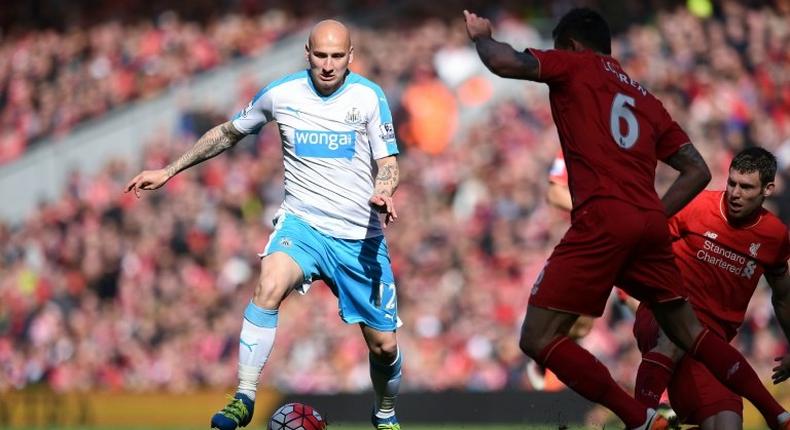 Newcastle United's midfielder Jonjo Shelvey (L) runs with the ball during the English Premier League football match between Liverpool and Newcastle United