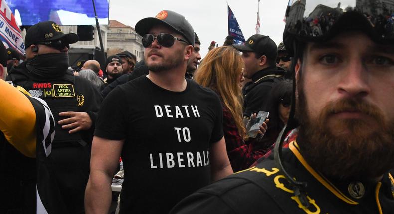 A member of the Proud Boys wearing a t-shirt that reads death to liberals stands with other Proud Boys in Freedom Plaza during a protest on December 12, 2020 in Washington, DC.