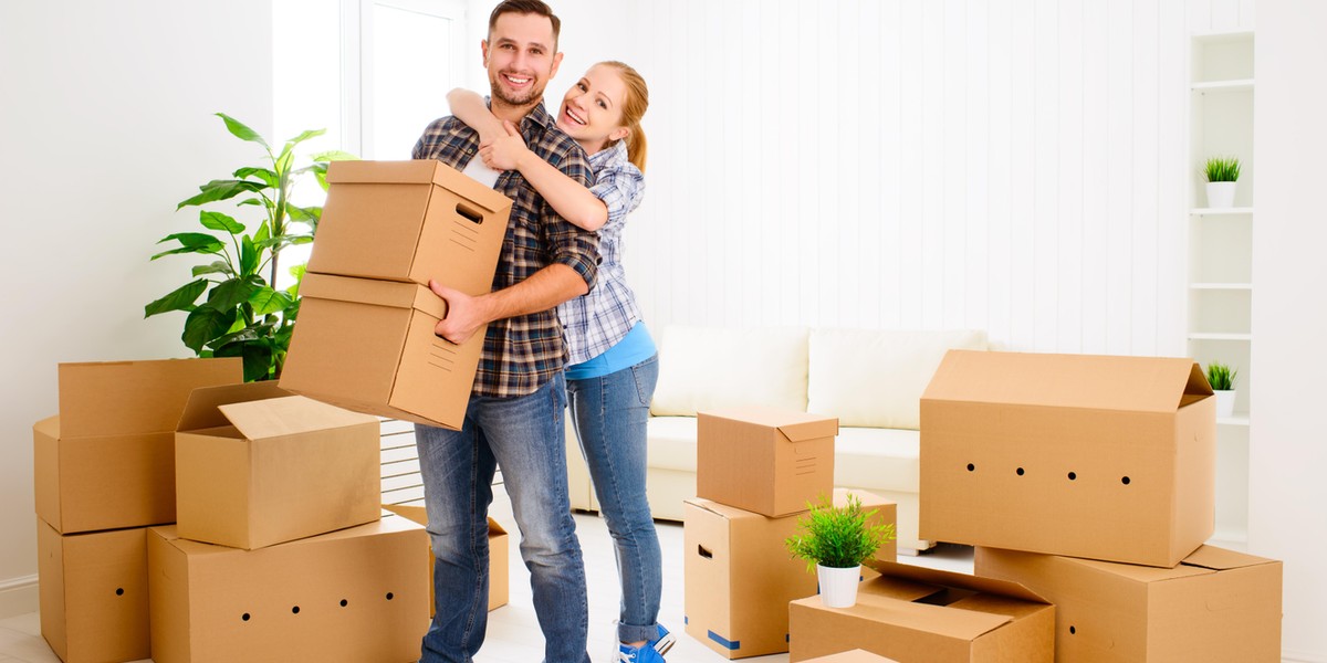 moving to a new apartment. Happy family couple and cardboard boxes.