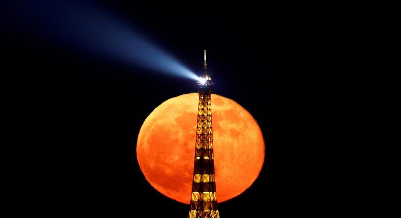 The full moon, known as the Super Pink Moon rises behind the Eiffel Tower in Paris, France.Christian Hartmann/Reuters