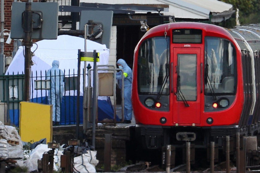 Emergency services tend to an injured woman following a blast on an underground train at Parsons Gre