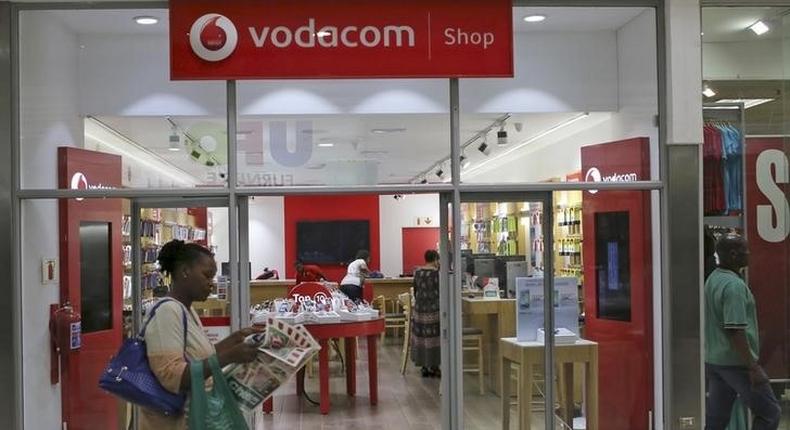 A shopper walks past a Vodacom shop in Johannesburg February 4, 2015.  REUTERS/Siphiwe Sibeko