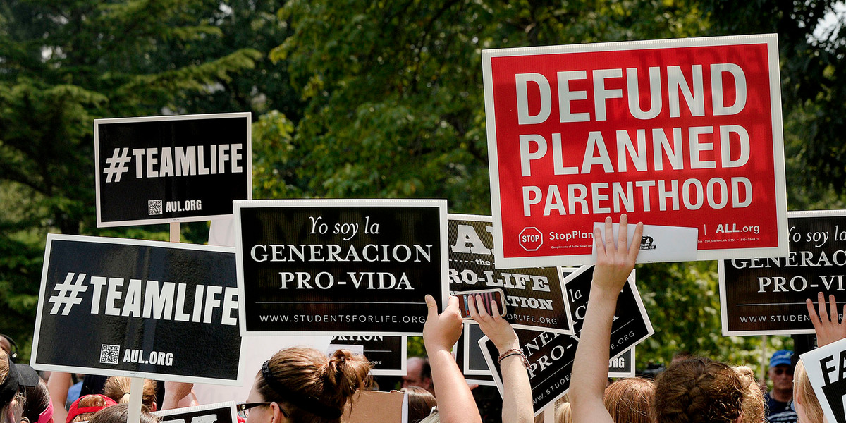 Anti-abortion activists hold a rally opposing federal funding for Planned Parenthood.