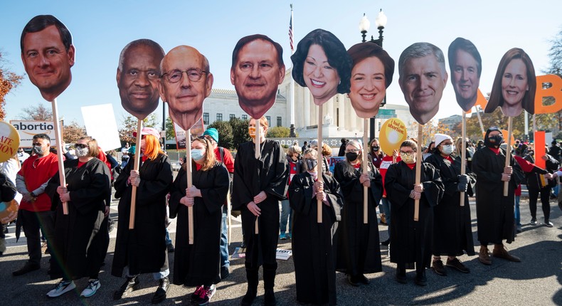 Reproductive rights activists hold cut out photos of the Supreme Court justices as oral arguments in Dobbs v. Jackson Women's Health Organization case are held on Wednesday, December 1, 2021.