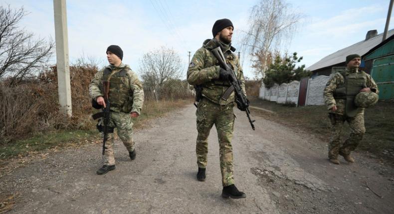 Ukrainian servicemen patrol in the streets of the village of Katerynivka, in the Lugansk region. The conflict in eastern Ukraine has been raging since 2014