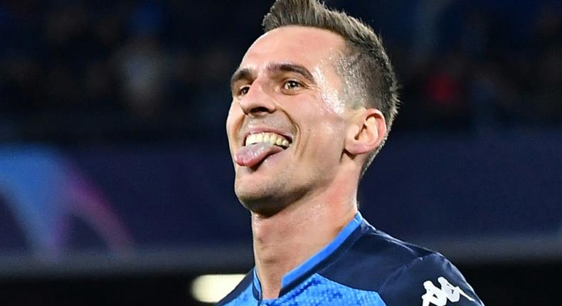 Napoli's Polish forward Arkadiusz Milik celebrates after scoring his second goal during the UEFA Champions League Group E football match Napoli vs Genk on December 10, 2019 at the San Paolo stadium in Naples.