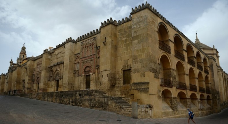 A lone tourist walks around The Mezquita in Cordova, one of Spain's interior cities that is being disproportionately hit by the drop in tourism