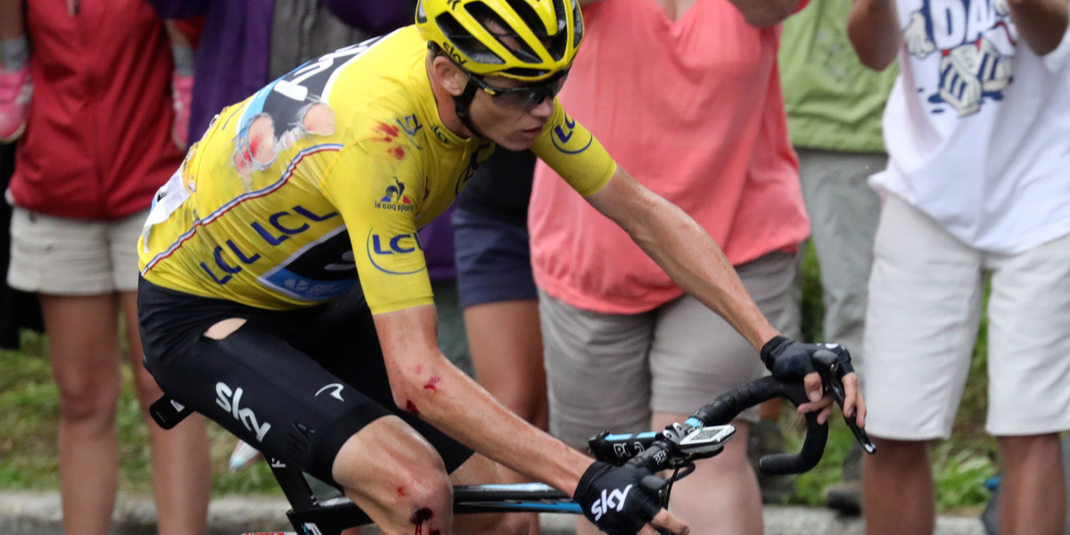 Chris Froome rides to the finish of stage 19 on his teammate Geraint Thomas' bike after he crashed in the rain.