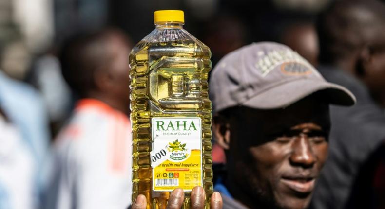 Inflation anger: A protester holds a bottle of cooking oil during a demonstration in Harare last August over the cost of food