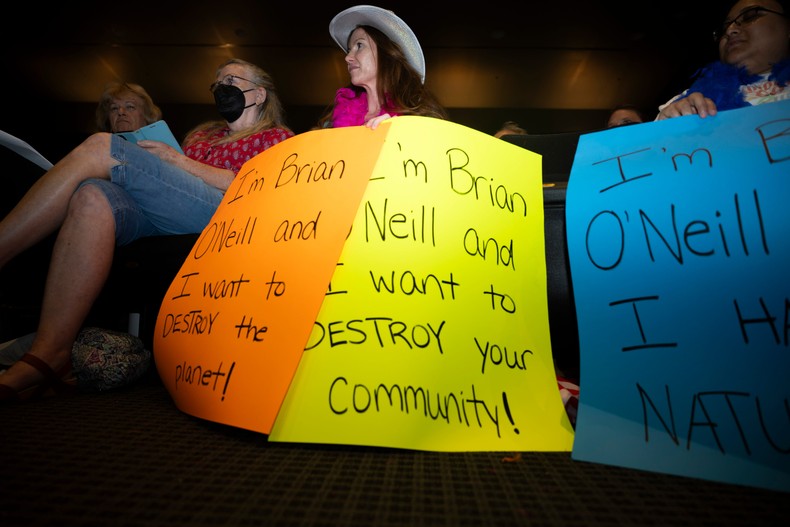 Residents hold signs directed at Brian O'Neill, the real estate developer behind the AI data center proposal in Upper Merion Township.Joe Lamberti for BI