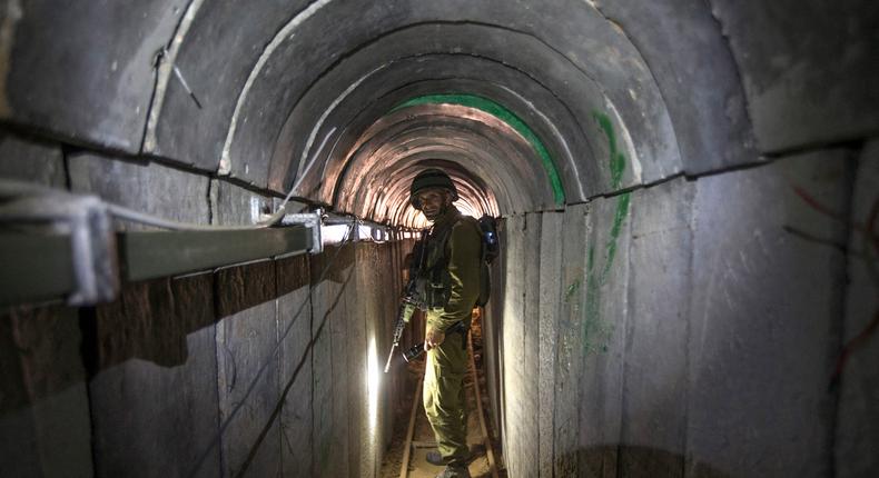 An Israeli army officer walks through a tunnel said to be used by Palestinian militants from the Gaza Strip.JACK GUEZ/POOL/AFP via Getty Images