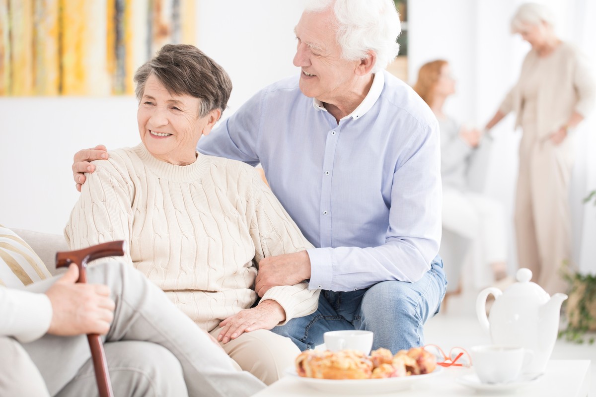 Happy,Senior,Couple,Enjoying,A,Meeting,With,Friends,At,Their