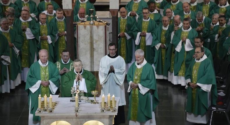 Archbishop of Paris and French cardinal Andre Vingt-Trois (3rdL) and archbishop of Lyon Philippe Barbarin (R) take part in a plenary meeting of the French Bishops' Conference on November 7, 2016 at Notre-Dame-du-Rosaire in Lourdes