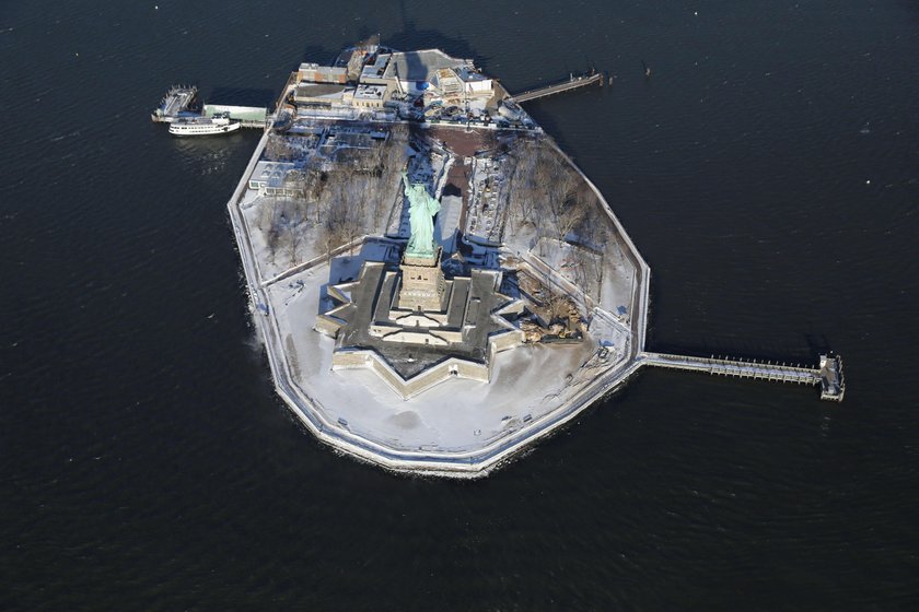 A sign announcing the closure of the Statue of Liberty, due to the U.S. government shutdown, sits ne