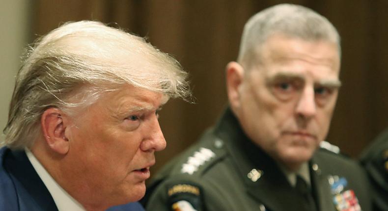 Then-President Donald Trump speaks as Joint Chiefs of Staff Chairman, Army Gen. Mark Milley looks on, on October 7, 2019.
