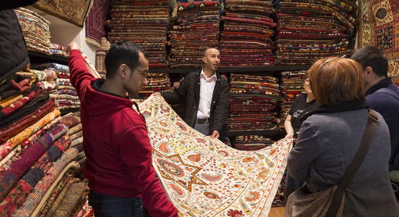 A rug salesman shows off a rug at The Grand Bazaar in Istanbul, Turkey.
