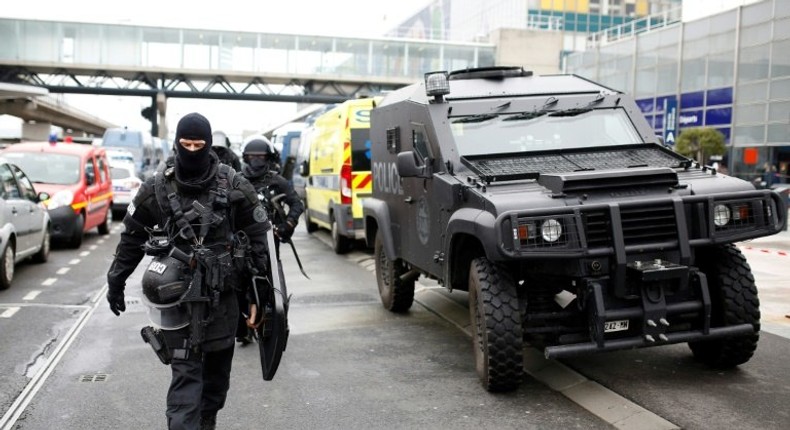 Police officers secure the area at Paris' Orly airport on March 18, 2017, after a man was shot dead when he tried to grab an officer's weapon