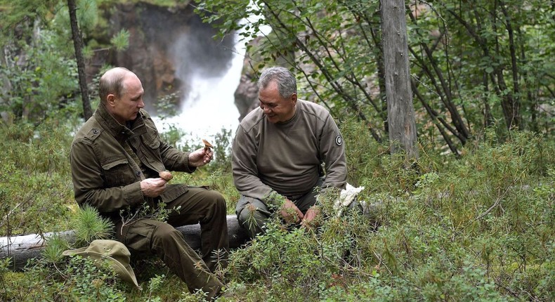 Russian President Vladimir Putin (L) shows mushrooms to Defense Minister Sergei Shoigu during his vacation in the remote Tuva region in southern Siberia, in August 2017.Alexey Nikolsky/Sputnik/AFP via Getty Images