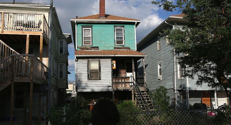 Valencia Terrell near an abandoned foreclosed home in 2015 in Atlantic City, New Jersey.