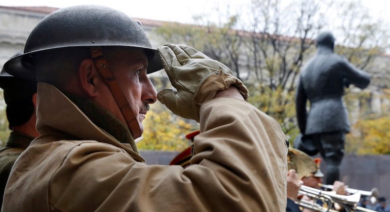 A re-enactor salutes during the U.S. World War I Centennial Commission ceremonial groundbreaking for the National World War I Memorial at Pershing Park, Thursday, Nov. 9, 2017, in Washington. The statue of Gen. Pershing, seen to the right, will someday overlook the memorial.