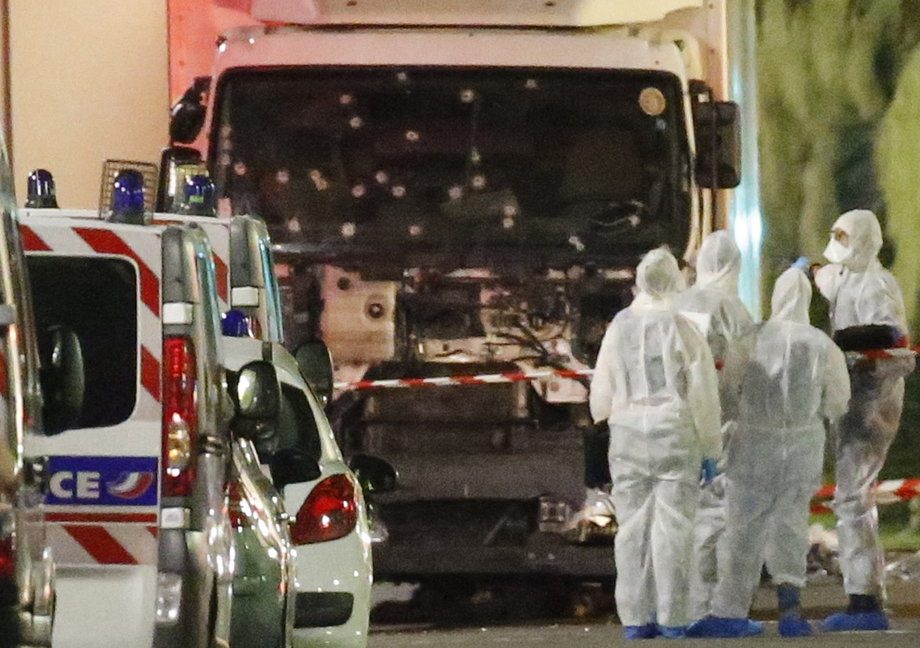 French police forces and forensic officers seen Friday next to the truck used in the attack.