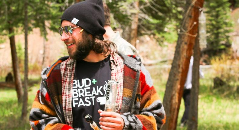 A guest enjoys a marijuana toke while on a Bud+Breakfast retreat.