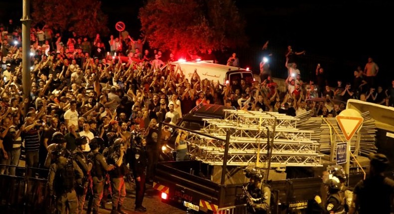 Palestinians celebrate outside the Al-Aqsa mosque compound on July 27, 2017, after more new Israeli security barriers were removed from the entrance