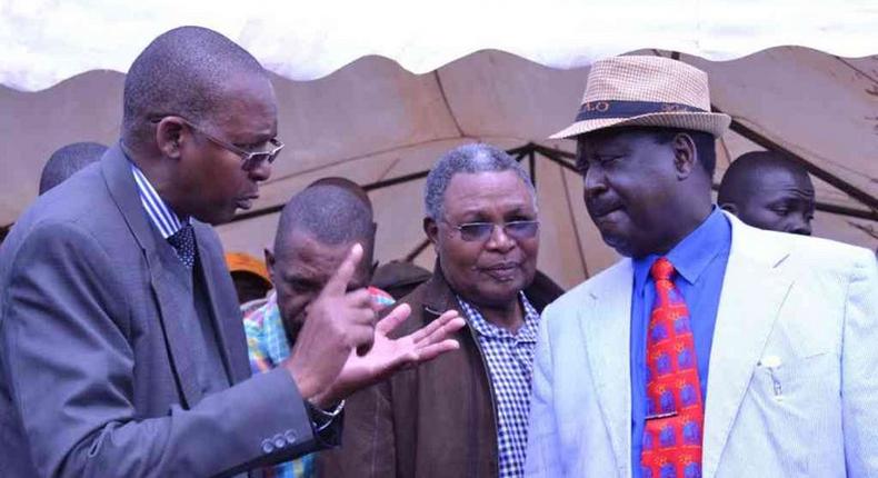 Taita Taveta governor John Mruttu explains a point to Cord leader Raila Odinga as Wundanyi MP Thomas Mwadeghu listen on at a past function last year.
