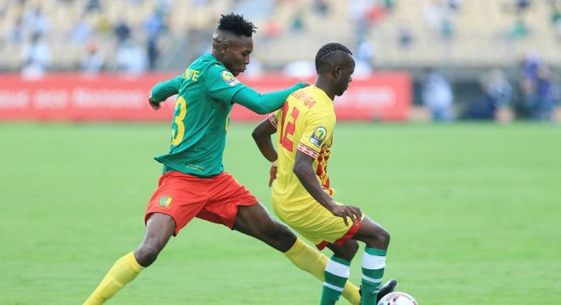 Thierry Tchuente (L) of Cameroon contests possession with Leeroy Mavunga of Zimbabwe during the African Nations Championship opener in Yaounde Saturday.