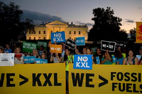 A small group of activists gather to celebrate the Obama administration's rejection of the Keystone 