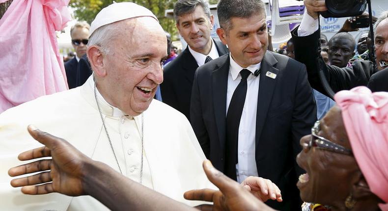 Pope Francis talks with a woman as he visits the refugee camp of Saint Sauveur in the capital Bangui, Central African Republic, November 29, 2015. REUTERS/Stefano Rellandini