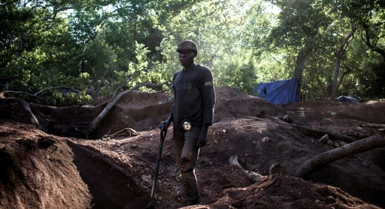 An illegal miner stands in an area rich with gold and rubies on the outskirts of Montepuez, Mozambique