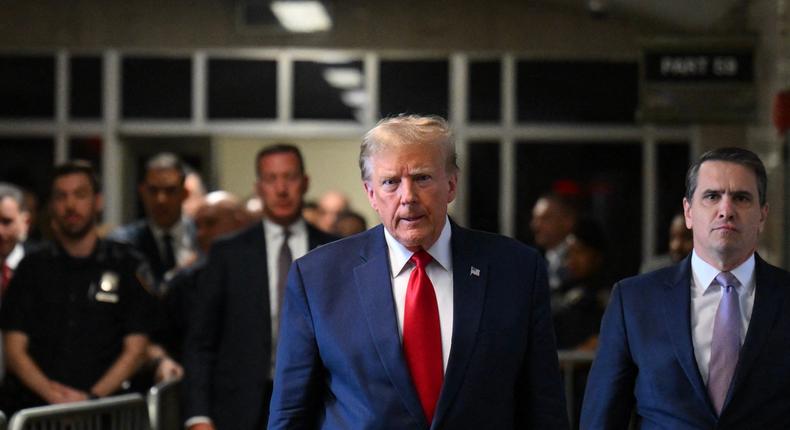 Former US President Donald Trump speaks to the press as he arrives at Manhattan Criminal Court in New York City. ANGELA WEISS/AFP via Getty Images