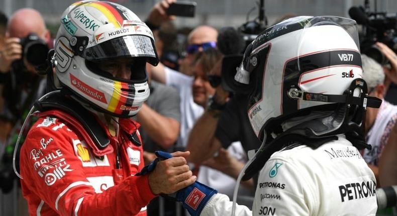 Mercedes driver Valtteri Bottas (right) shakes hands with Ferrari's Sebastian Vettel after the Austraian Grand Prix at the Red Bull Ring in Spielberg on July 9, 2017