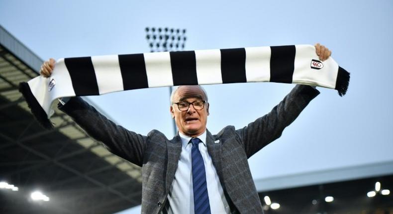 Fulham's new manager Claudio Ranieri poses with a team scarf on the pitch at the club's Craven Cottage stadium on November 16, 2018 after replacing sacked Slavisa Jokanovic.