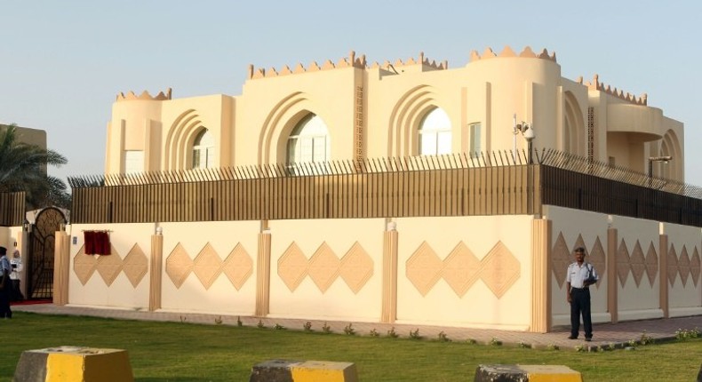 Security guards stand outside the Taliban political office in the Qatari capital Doha