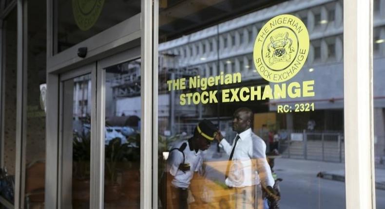 A security officer checks a man outside the Nigerian Stock Exchange in Lagos.    REUTERS/Akintunde Akinleye