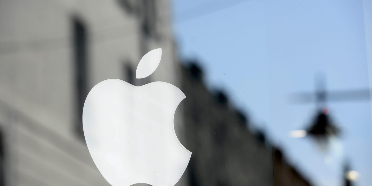 An Apple logo is seen in the window of an authorised apple reseller store in Galway