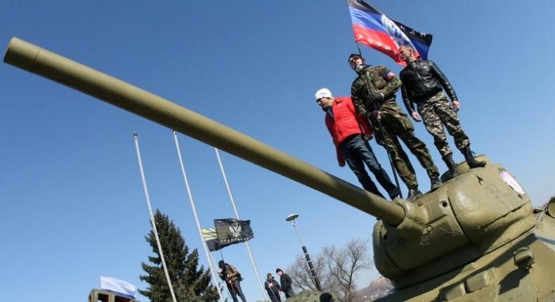 Pro-Russian activists stand on top of a tank outside a museum in Donetsk, Ukraine, in March 2014