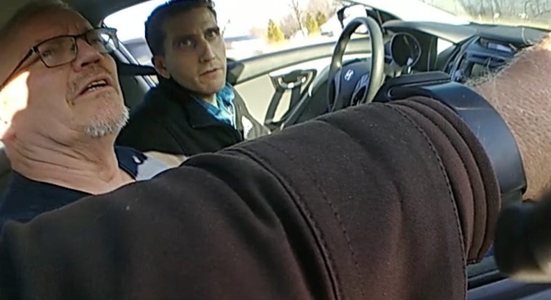 The Idaho killings suspect (left) and his dad can be seen in police body camera footage during a traffic stop in Indiana on December 15.Hancock County Sheriff's Department