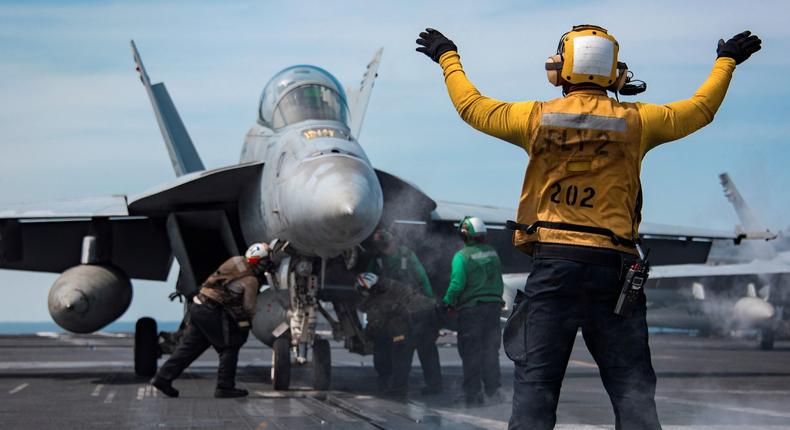 Sailors conduct flight operations aboard the U.S. Navy Nimitz-class aircraft carrier USS Carl Vinson in the western Pacific Ocean .