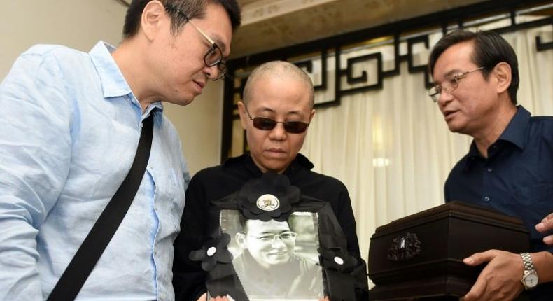 Liu Xia (C) was last seen in government-released images of her dissident husband's sea burial on July 15, and China has been under international pressure to free her and let her travel abroad